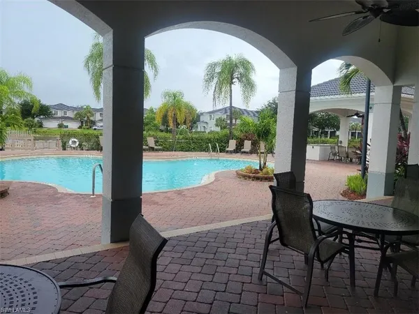 a view of a chairs and table in patio