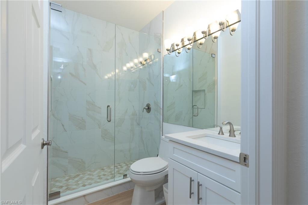 15618 Summit Pl Circle, Unit 396 Naples, FL 34119 - Photo 9 of 41 a bathroom with a sink a toilet and shower