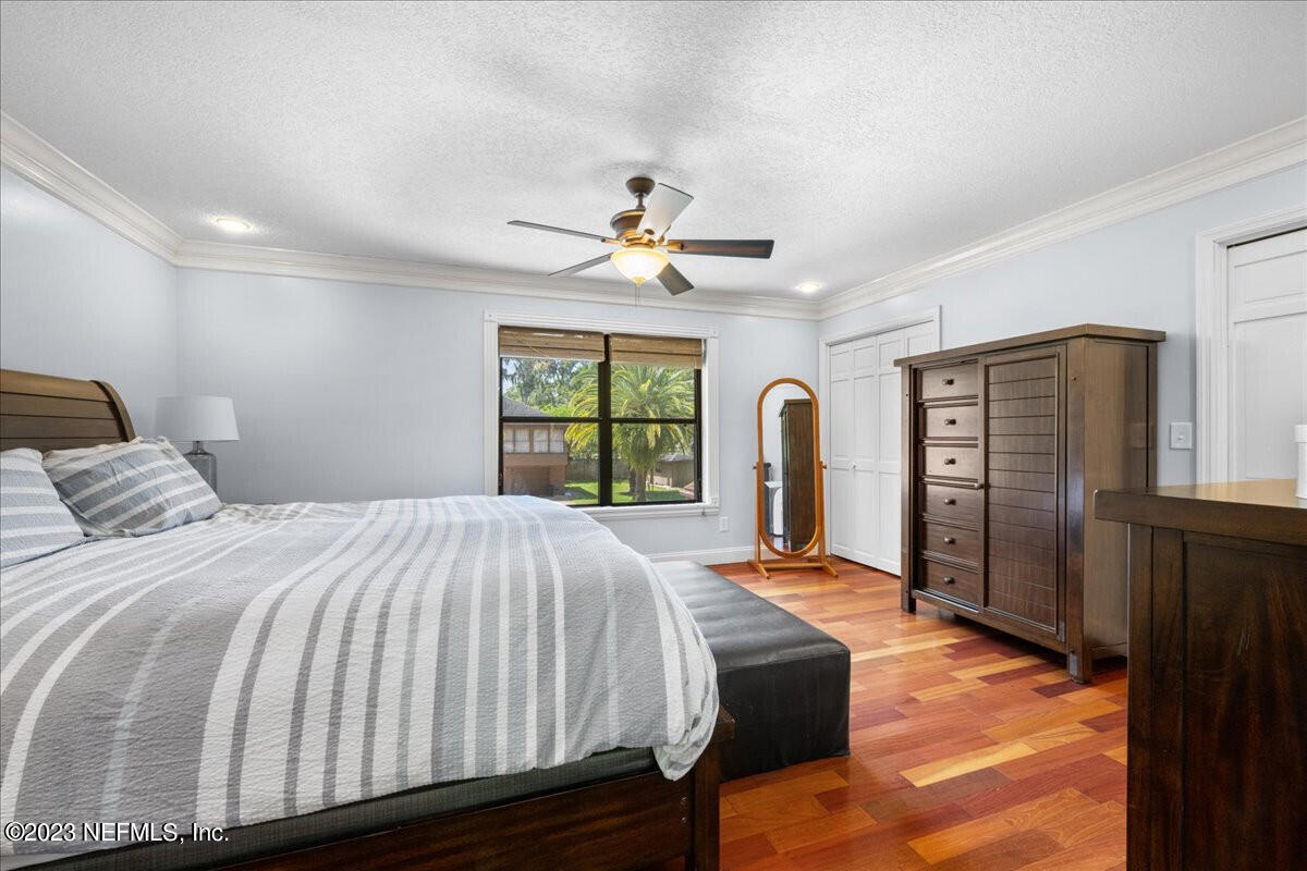 174 Eventide Drive Fleming Island, FL 32003 - Photo 12 of 24 a bed sitting in a spacious bedroom next to a window