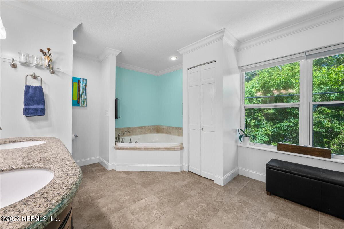 174 Eventide Drive Fleming Island, FL 32003 - Photo 15 of 24 a spacious bathroom with a granite countertop tub sink and mirror