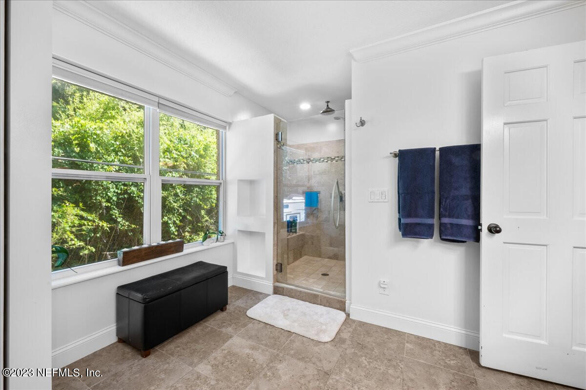 174 Eventide Drive Fleming Island, FL 32003 - Photo 16 of 24 a room with a large window and a glass door