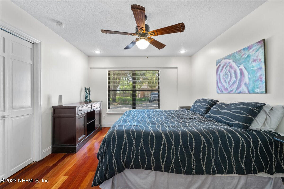 174 Eventide Drive Fleming Island, FL 32003 - Photo 18 of 24 a bed room with a bed and a large window