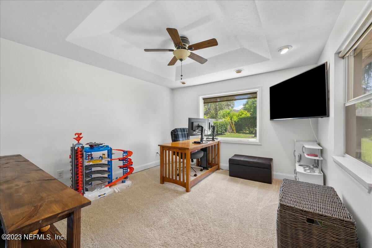 174 Eventide Drive Fleming Island, FL 32003 - Photo 20 of 24 a living room with furniture and a flat screen tv