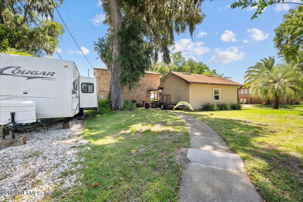 174 Eventide Drive Fleming Island, FL 32003 - Photo 23 of 24 a backyard of a house with yard and outdoor seating