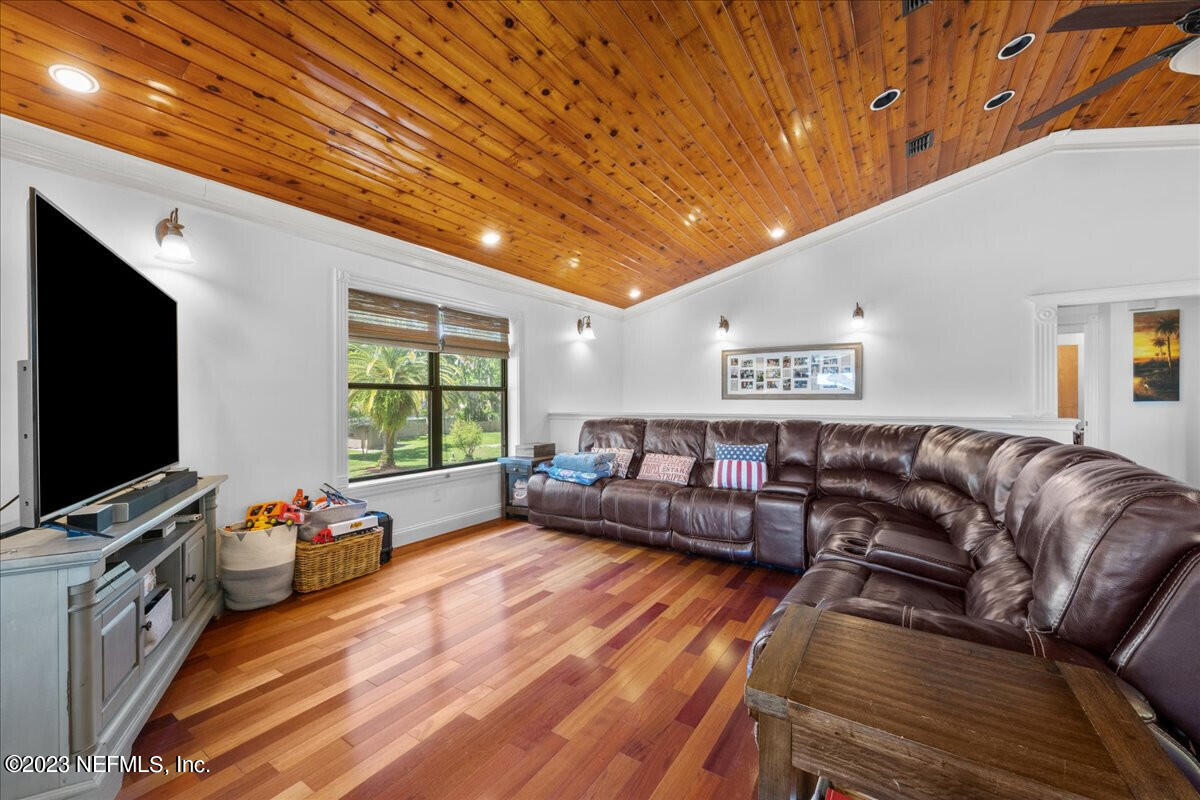 174 Eventide Drive Fleming Island, FL 32003 - Photo 4 of 24 a living room with furniture and a flat screen tv