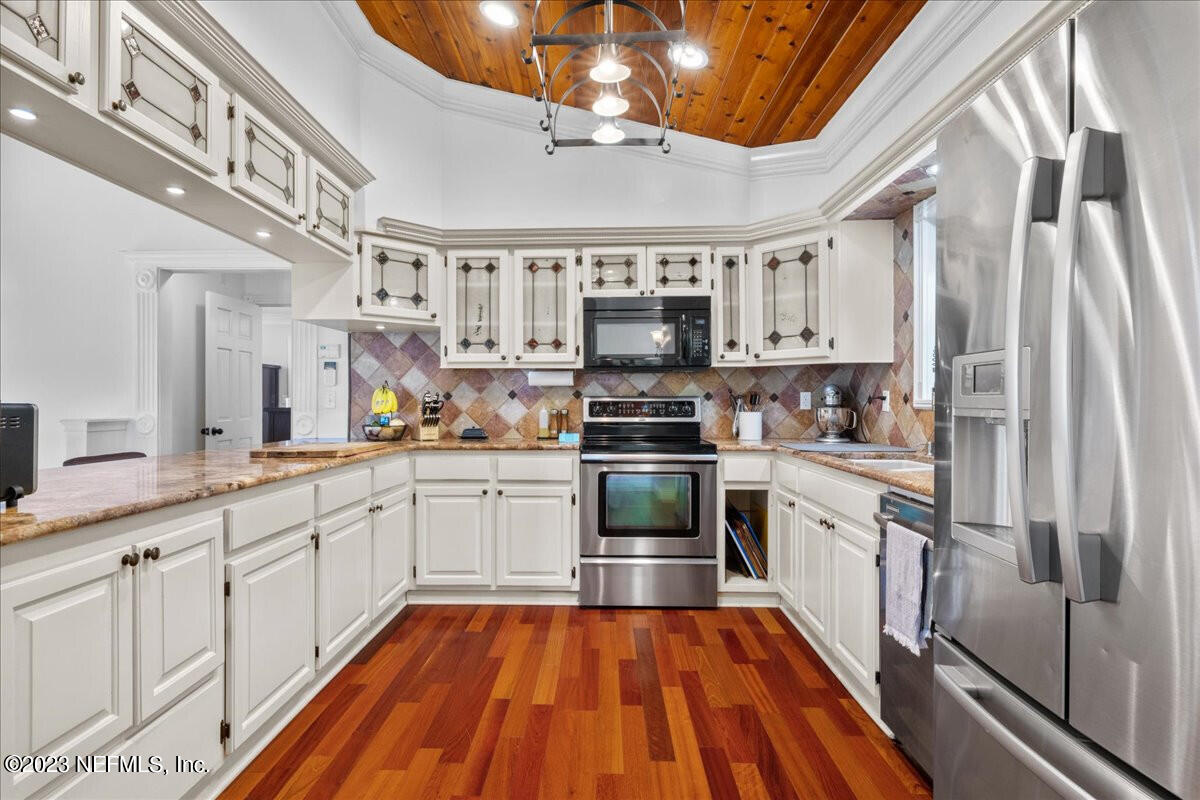 174 Eventide Drive Fleming Island, FL 32003 - Photo 5 of 24 a kitchen with stainless steel appliances granite countertop a refrigerator and a sink