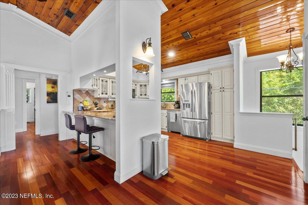 174 Eventide Drive Fleming Island, FL 32003 - Photo 6 of 24 a kitchen with stainless steel appliances wooden floor and a refrigerator