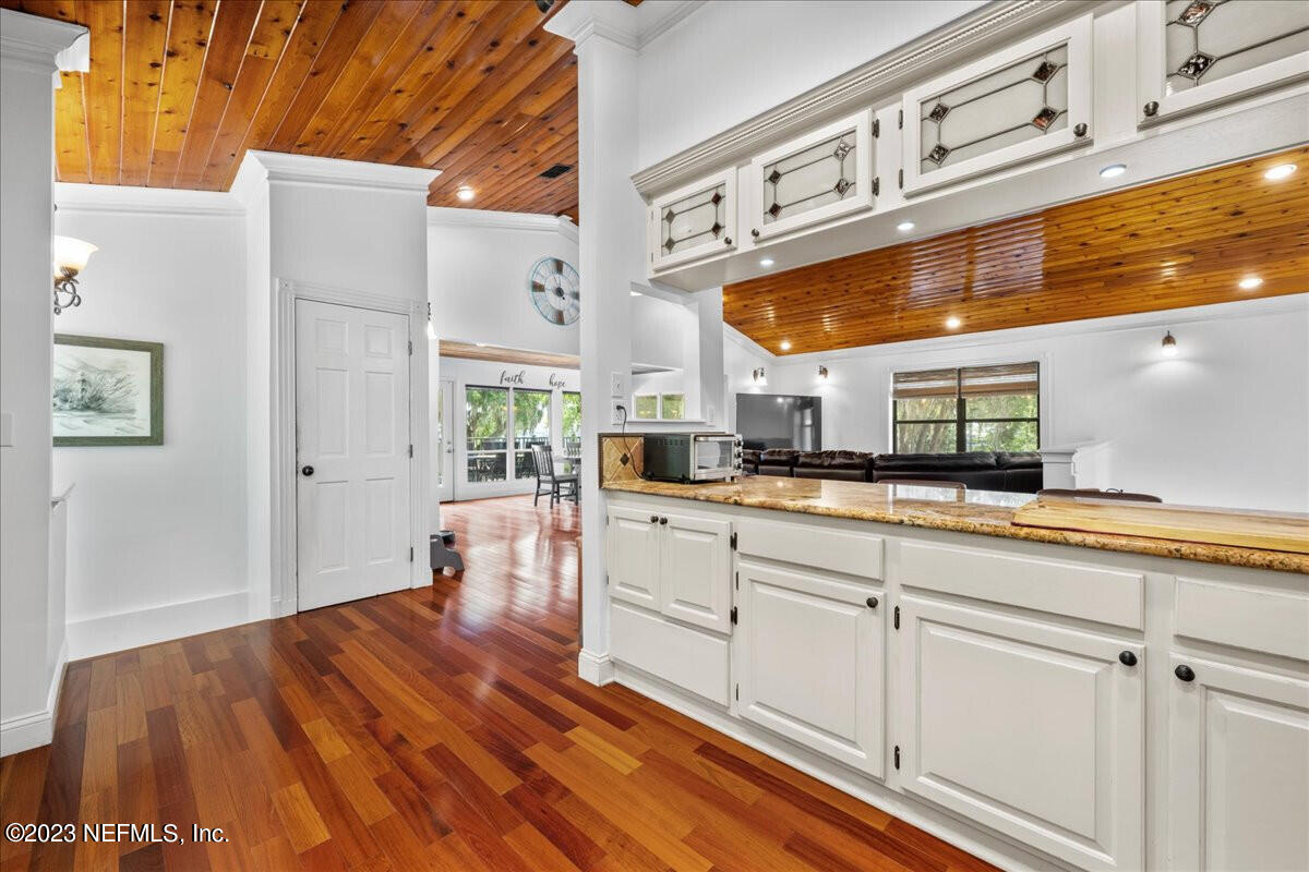 174 Eventide Drive Fleming Island, FL 32003 - Photo 7 of 24 a kitchen with stainless steel appliances granite countertop a sink and cabinets