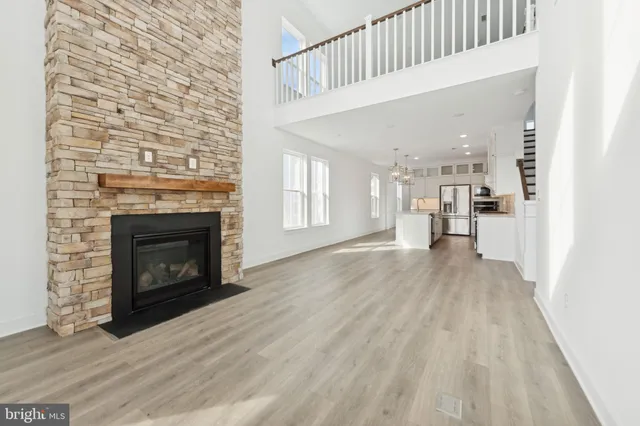 a view of a livingroom with wooden floor and a fireplace