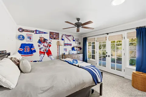 a bedroom with a bed and a large window with the outer view