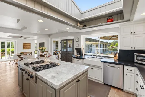 a kitchen with a stove a sink dishwasher and a refrigerator