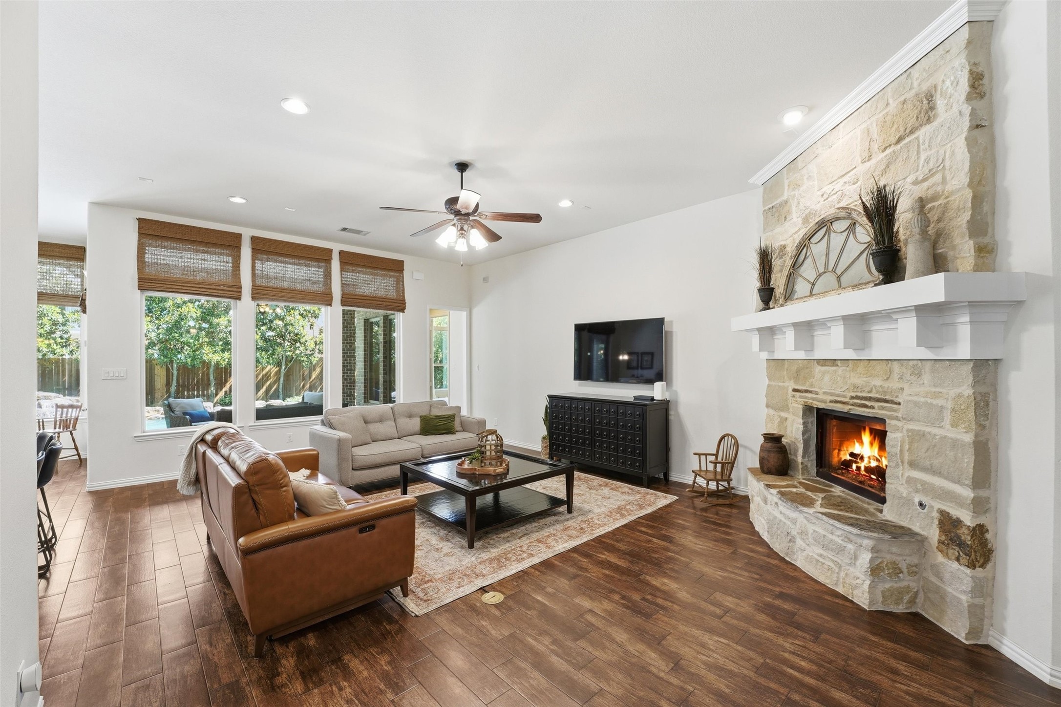 27118 Cross Pointe Court Fulshear, TX 77441 - Photo 5 of 40 Natural light fills the living room with a view of the backyard oasis