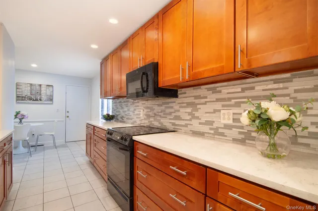 a kitchen with stainless steel appliances granite countertop a stove a microwave and cabinets
