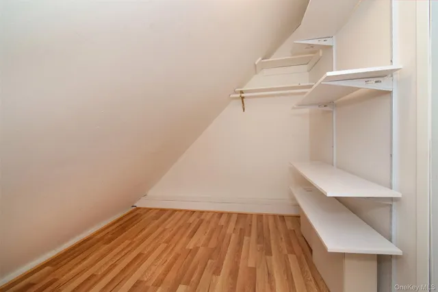 a bedroom with a bed work place and a window