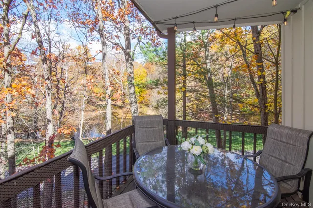 a view of balcony with wooden floor and outdoor seating