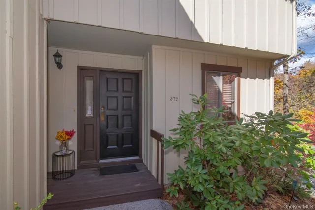 a view of a hallway with wooden floor and entryway