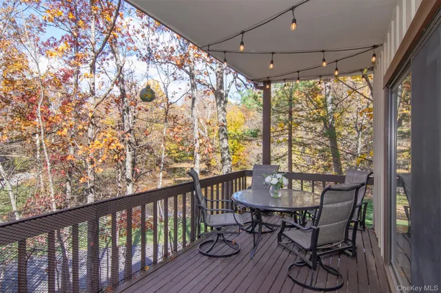 a view of a balcony with furniture and wooden floor