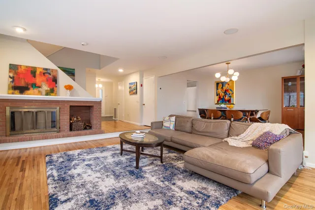 a view of a dining room with furniture wooden floor and chandelier