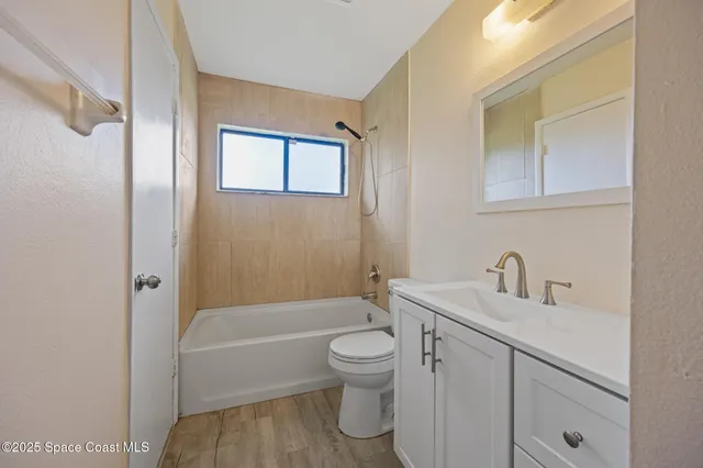 a white kitchen with sink and window