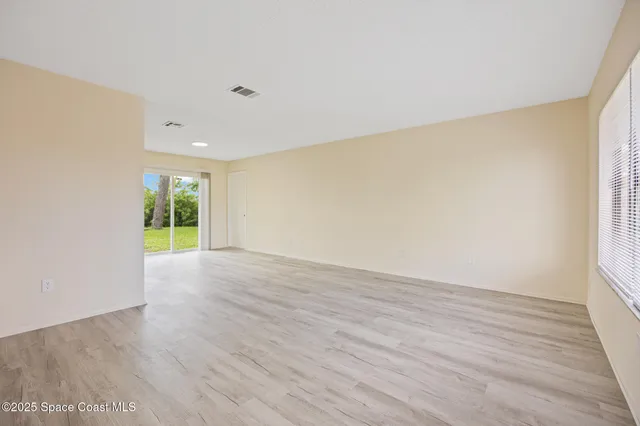 a view of a room with wooden floor and bathroom view