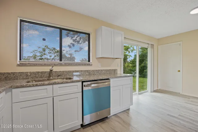 a view of empty room with wooden floor and fireplace