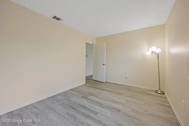 a kitchen with granite countertop a refrigerator and a stove top oven