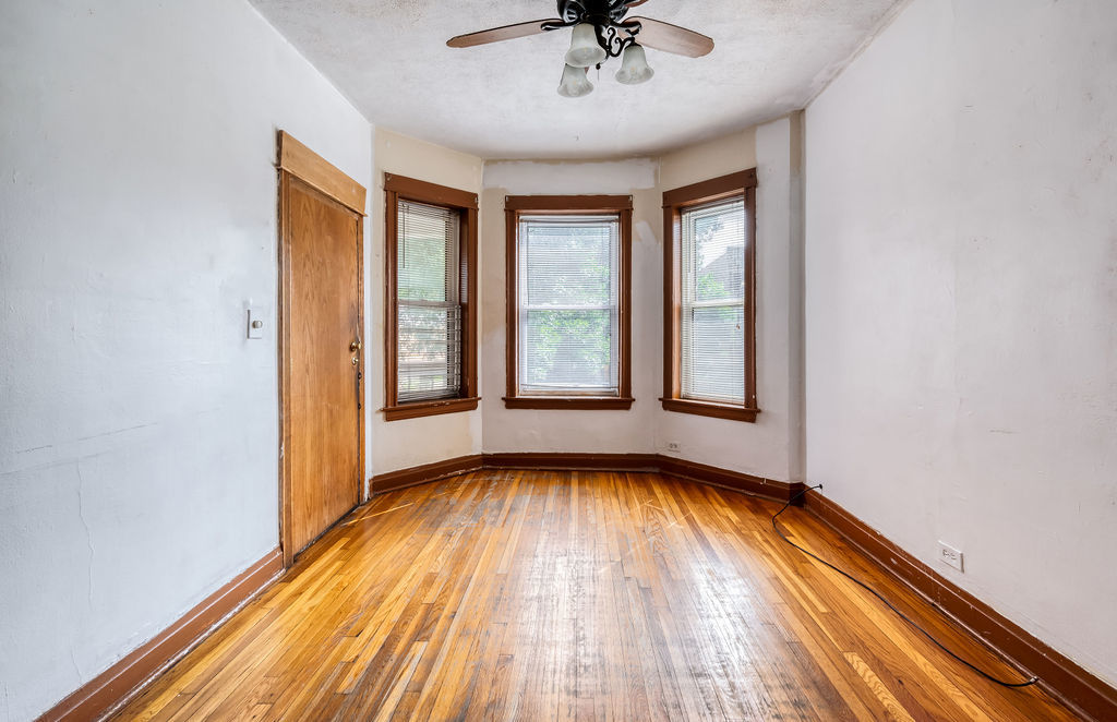 1738 North Harding Avenue Chicago, IL 60647 - Photo 11 of 21 a view of an empty room with a window and wooden floor