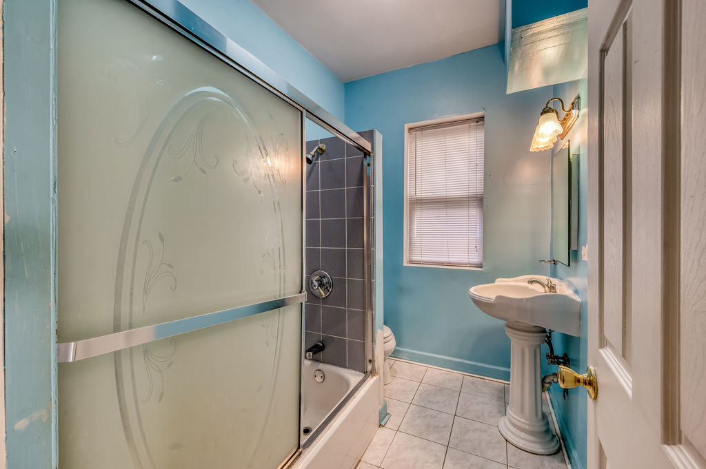 1738 North Harding Avenue Chicago, IL 60647 - Photo 14 of 21 a bathroom with a sink mirror and toilet