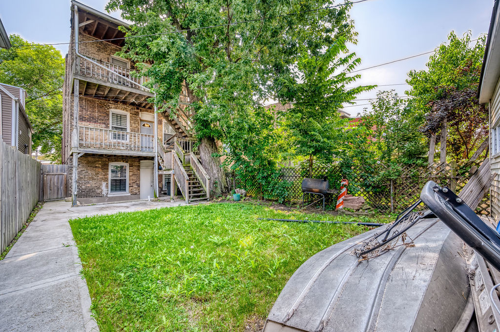 1738 North Harding Avenue Chicago, IL 60647 - Photo 20 of 21 a front view of a house with a yard