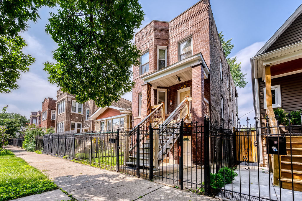 1738 North Harding Avenue Chicago, IL 60647 - Photo 2 of 21 a front view of a house with a small yard and plants
