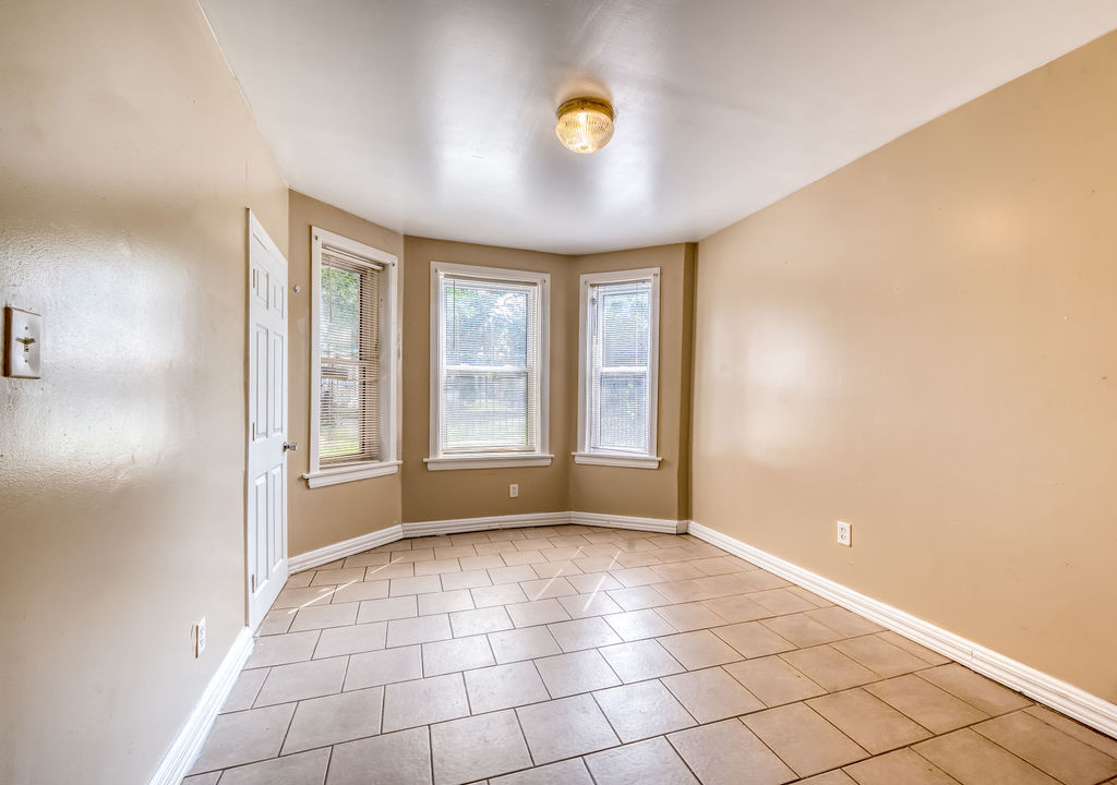 1738 North Harding Avenue Chicago, IL 60647 - Photo 6 of 21 a view of an empty room with window and chandelier fan