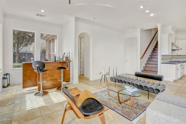 a living room with furniture and kitchen view