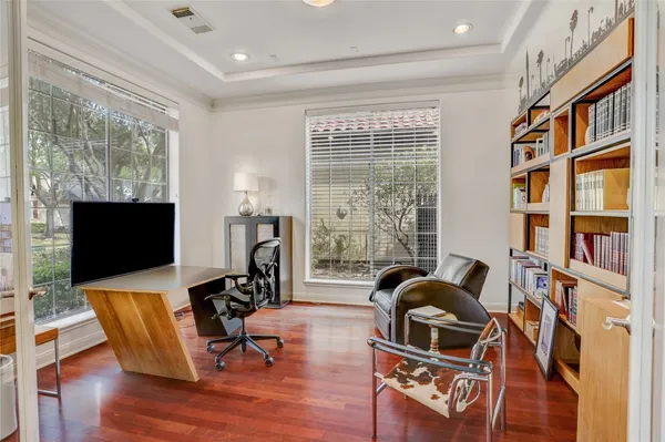 a living room with furniture and view of kitchen