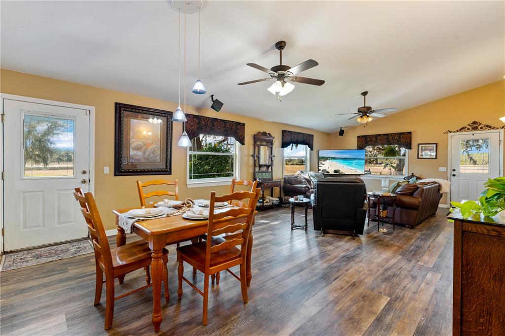 9504 Fort King Road Dade City, FL 33525 - Photo 6 of 51 a view of a dining room with furniture a chandelier and wooden floor