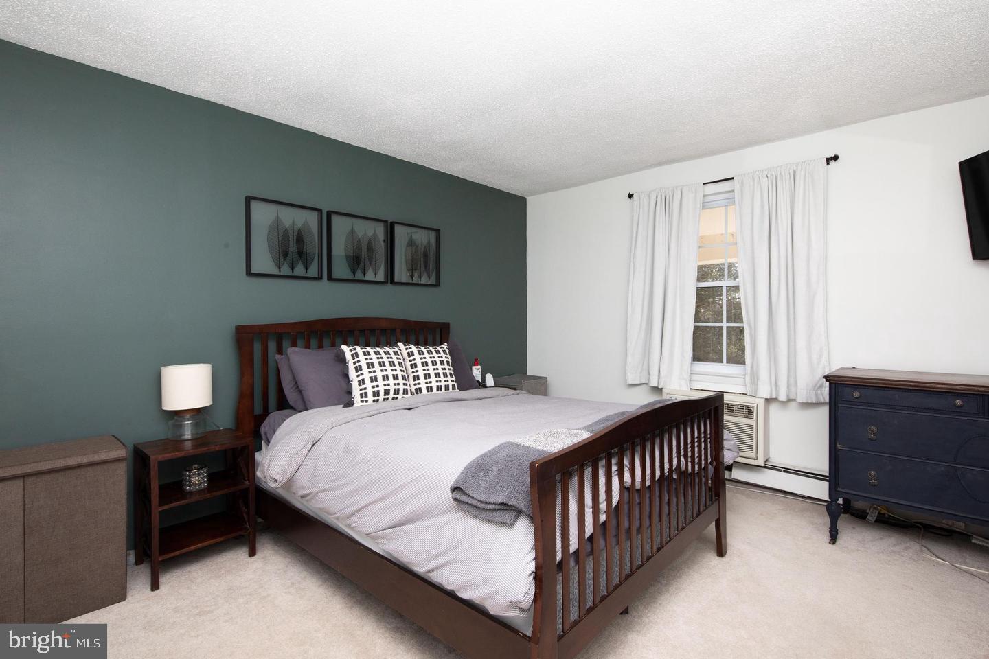 250 Ridge Pike, Unit 346B Lafayette Hill, PA 19444 - Photo 14 of 27 a bedroom with a bed and a window