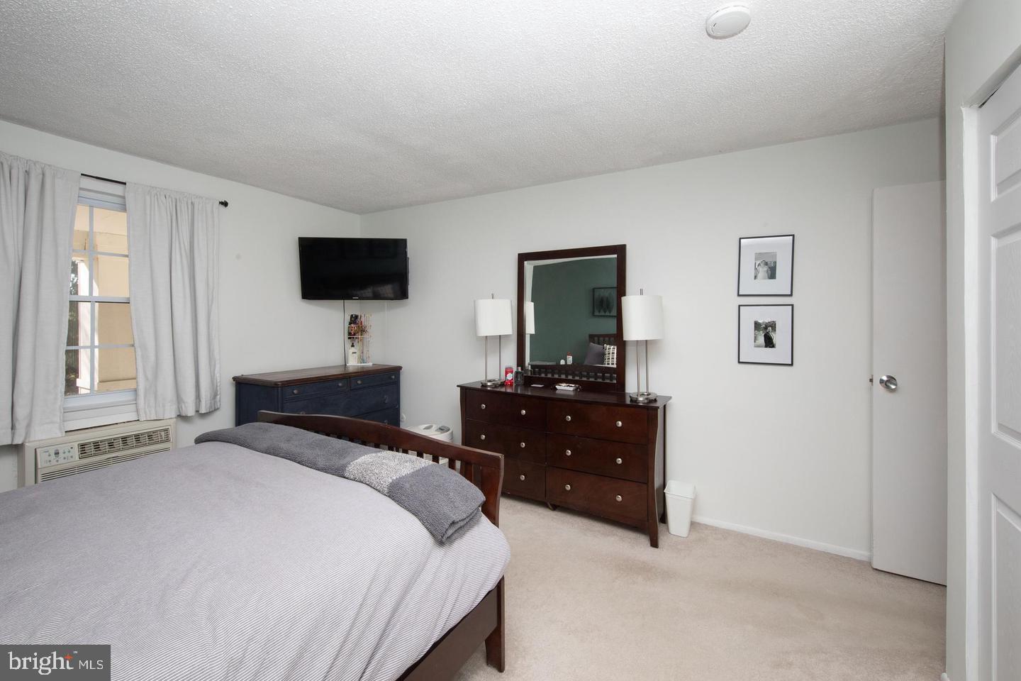 250 Ridge Pike, Unit 346B Lafayette Hill, PA 19444 - Photo 16 of 27 a bedroom with a bed and a flat screen tv