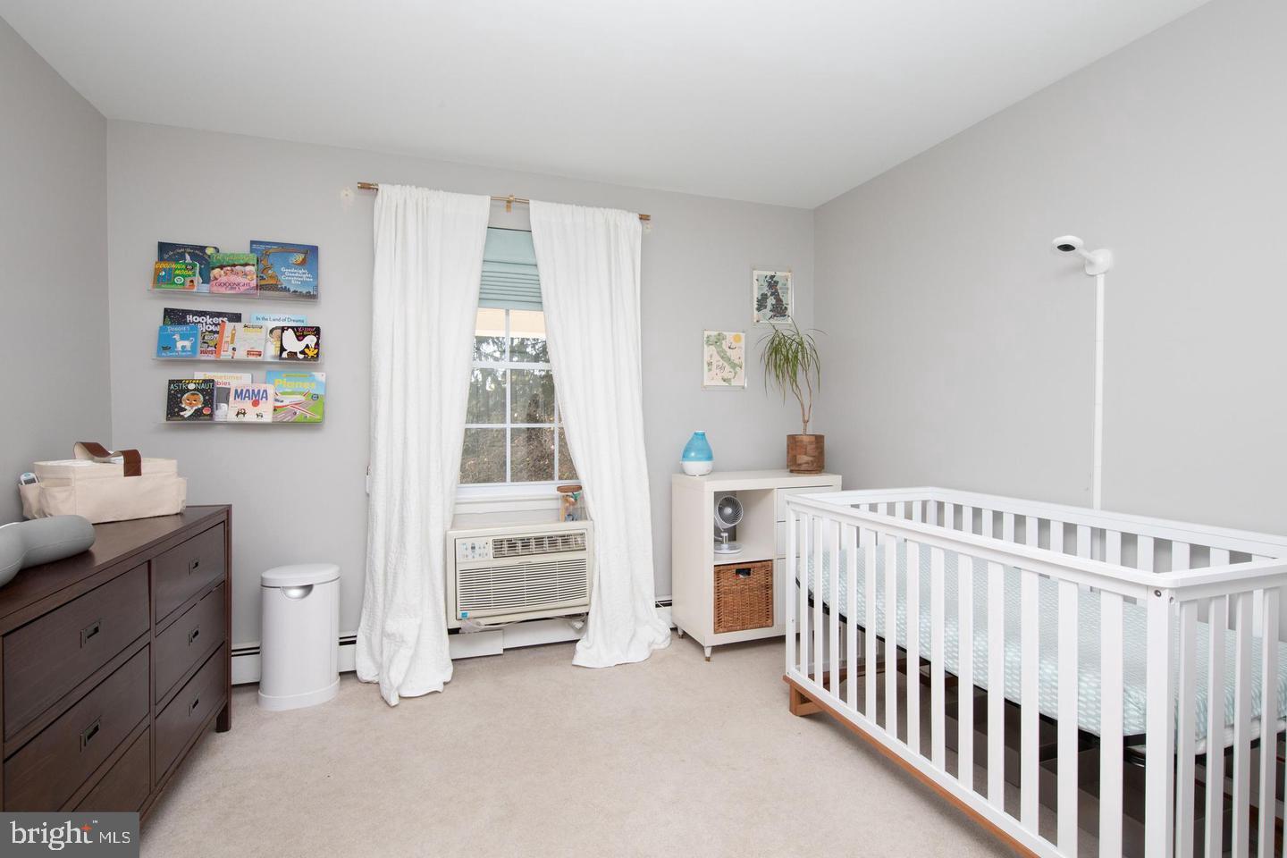 250 Ridge Pike, Unit 346B Lafayette Hill, PA 19444 - Photo 17 of 27 a view of a bedroom with baby crib and a window