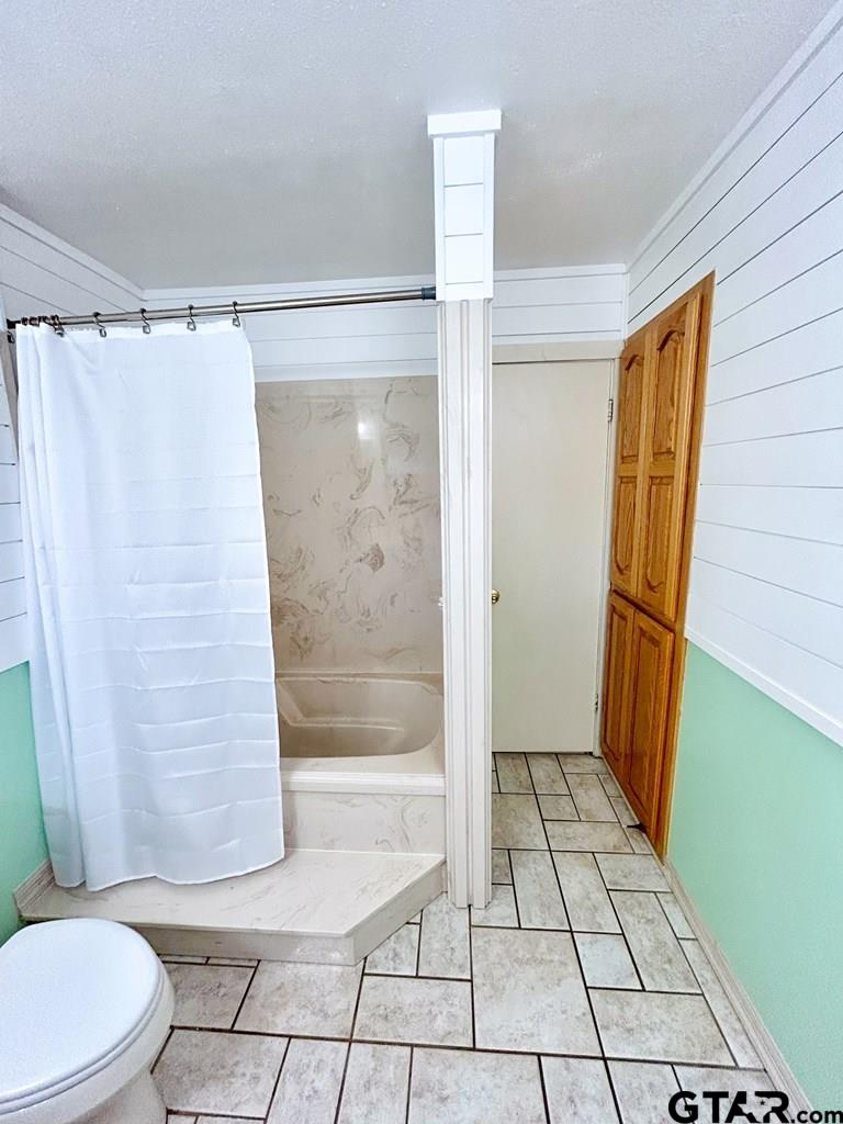 213 Sherry Lane Palestine, TX 75803 - Photo 13 of 25 a bathroom with a shower and toilet