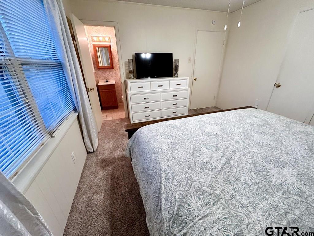 213 Sherry Lane Palestine, TX 75803 - Photo 21 of 25 a bedroom with a bed and flat screen tv