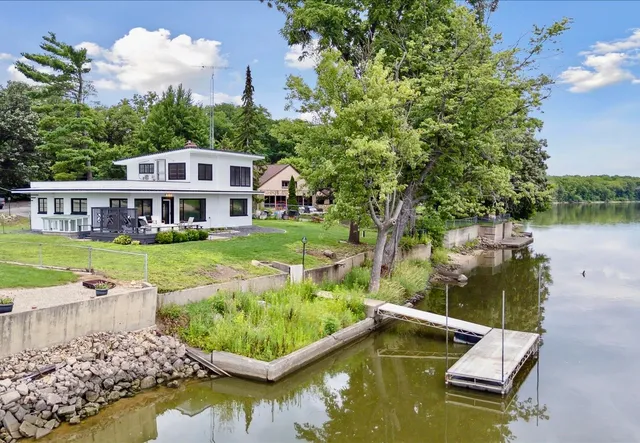 a view of a house with swimming pool and a yard