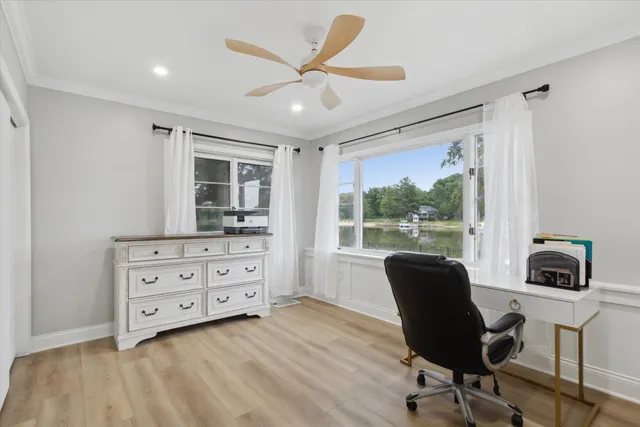 a view of a workspace with furniture and a window