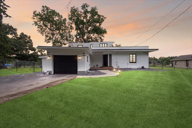 a front view of house with yard and outdoor seating