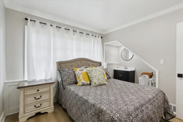 a bedroom with a bed and closet with mirror