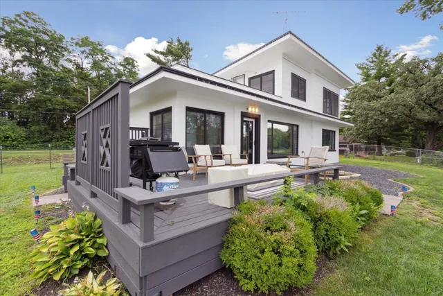 a view of a house with backyard and sitting area