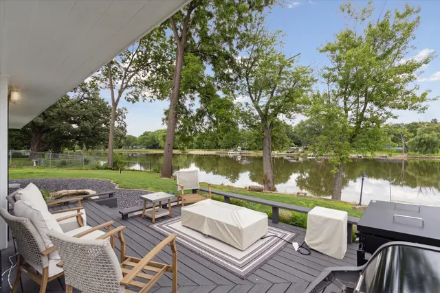 a view of a lake with furniture
