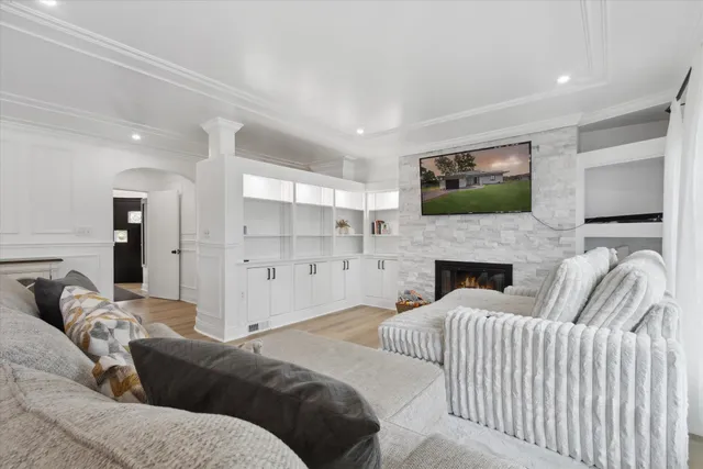 a living room with furniture a flat screen tv and a fireplace