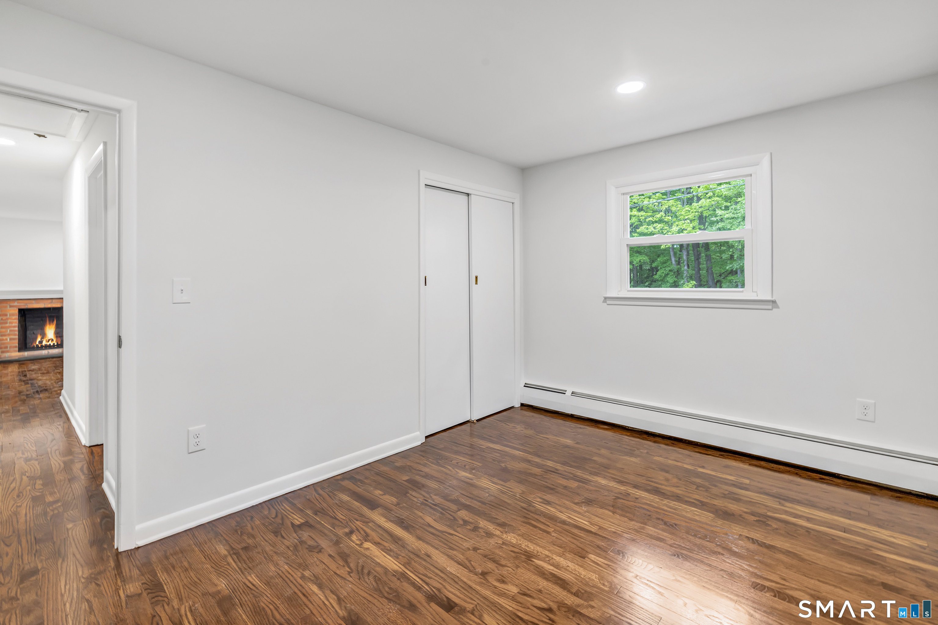 7 Longview Road Newtown, CT 06482 - Photo 24 of 40 a view of an empty room with wooden floor and a window