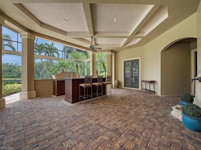 a view of a porch with furniture and a backyard