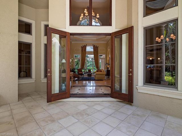 a living room with fireplace furniture and a large window