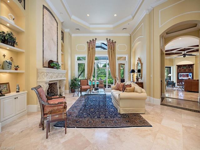 a living room with furniture and large windows